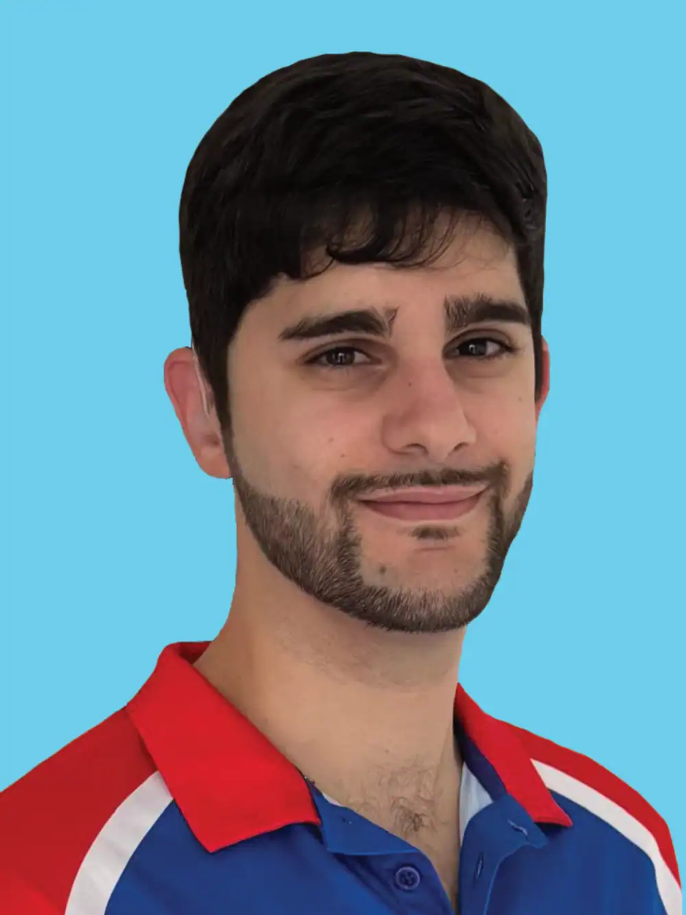 A man with short dark hair and a trimmed beard, wearing a blue and red collared shirt, poses in front of a plain light blue background.